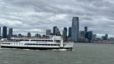 NEW YORK NY - JUN 18: Ferry by Statue City Cruises running from Manhattan to Statue of Liberty in New York City, as seen on June 18, 2022.