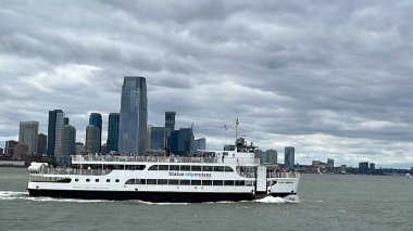NEW YORK NY - JUN 18: Ferry by Statue City Cruises running from Manhattan to Statue of Liberty in New York City, as seen on June 18, 2022.