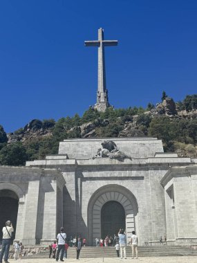 EL ESCORIAL, SPAIN - AUG 15: Holy Cross at Basilica of the Holy Cross of the Valley of the Fallen in El Escorial, Spain, as seen on Aug 15, 2024. It is the largest cross in the world. clipart