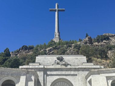 EL ESCORIAL, SPAIN - AUG 15: Holy Cross at Basilica of the Holy Cross of the Valley of the Fallen in El Escorial, Spain, as seen on Aug 15, 2024. It is the largest cross in the world. clipart