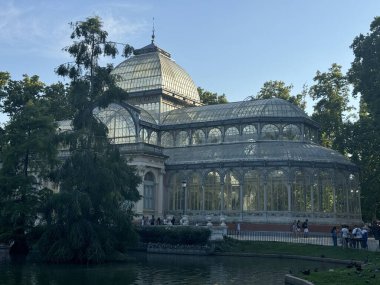 MADRID, SPAIN - AUG 12: Palacio de Cristal conservatory in El Retiro Park in Madrid, Spain, as seen on Aug 12, 2024. clipart