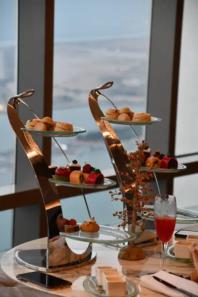 stock image ABU DHABI, UAE - JAN 1: Afternoon High Tea at the Observation Deck at 300 at the Conrad Hotel in Abu Dhabi, UAE, as seen on Jan 1, 2024.