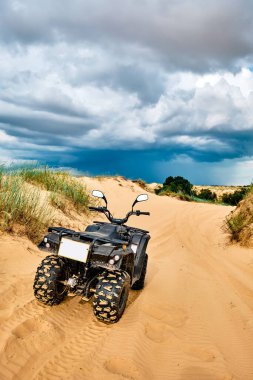 Oleshky Sands is a desert in Ukraine. Quad bike on a sandy road. 