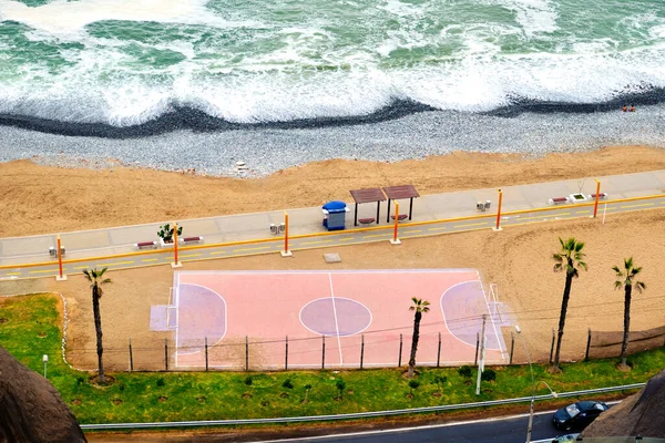 Mini soccer field on the shores of the Pacific Ocean in Lima, Peru.
