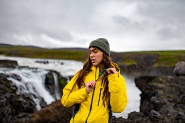 Rugged Waterfall Peyzajı 'nda Sarı Ceketli Kaşif