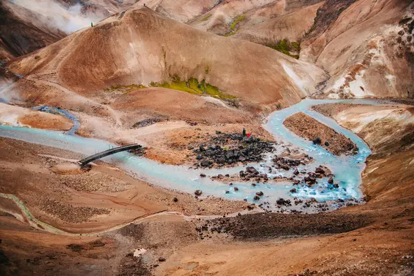 stock image Geothermal River in Snowy Mountainous Landscape with Steam Vents