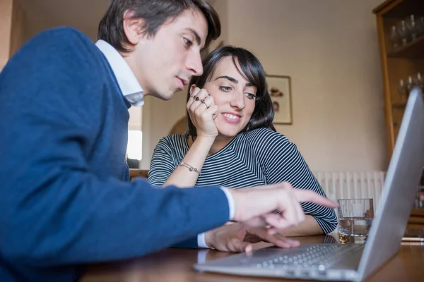 オンラインバンキングサービスを利用して 若いカップルが一緒に請求書を計算し 議論し 予算を計画する — ストック写真