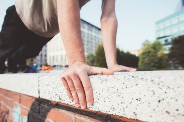 Close up fitness athletic man doing pushup training outdoors 