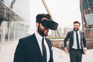 Elegant executive professional businessman bearded using 3D viewer outdoor exploring metaverse cyberspace