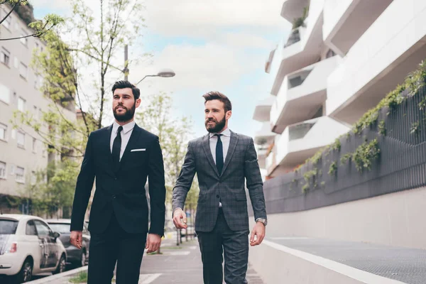 Two Young Elegant Businessmen Walking Outdoors Together Streets Discussing Chatting — Fotografia de Stock