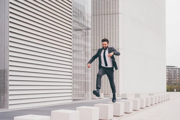 Energetic Young Bearded Professional Businessman Jumping Mid Air — Zdjęcie stockowe