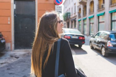 Arkaya bakan genç bayan yürüyor