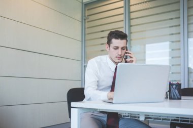 Kafkasyalı genç işadamı akıllı telefonlardan bahsediyor.