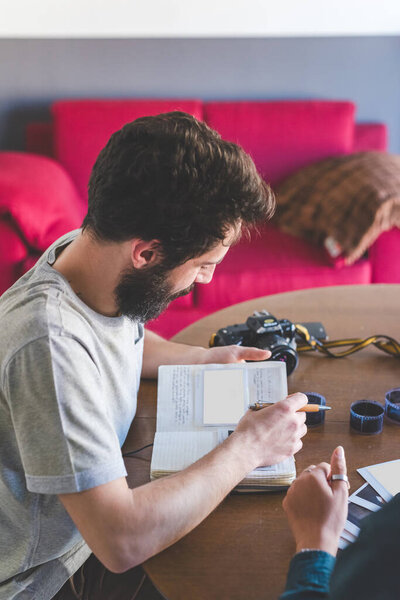 Young Bearded Man Sitting Home Table Writing Agenda Stock Picture