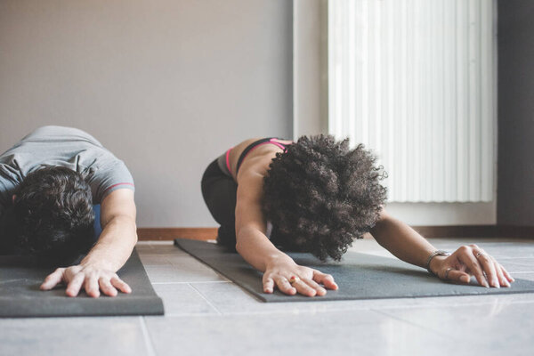 Multiethnic Couple Home Practicing Sport Doing Fitness Yoga Stock Image
