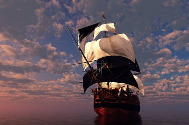 Günbatımında denizde eski bir yelkenli.