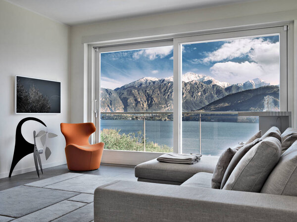 Современная гостиная с диваном и креслом с видом на озеро Комо