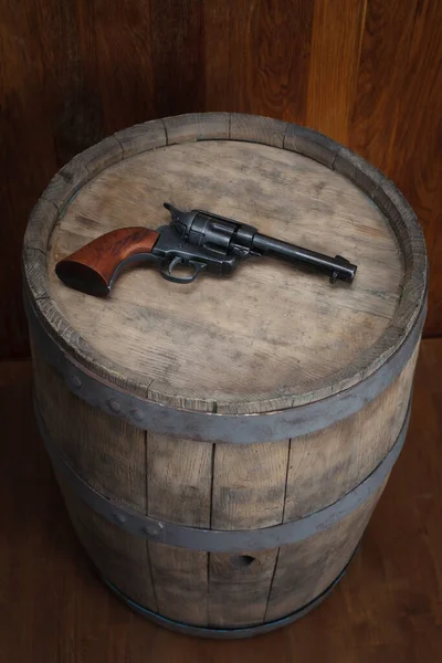 Old west revolver 45 cal on vintge wooden barrel