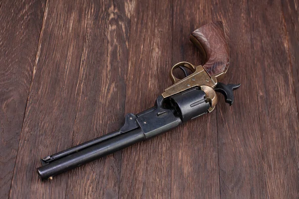 Old West gun - Percussion Army Revolver on wooden table