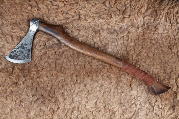 stock image Battle axe on sheep fur background