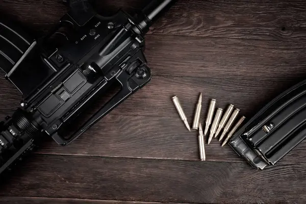 Rifle and Ammunition with magazine on wooden table background