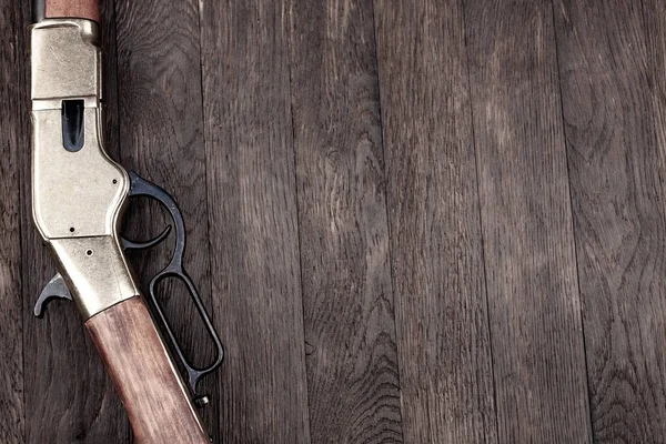 Old west guns. Lever-action repeating guns on wooden table