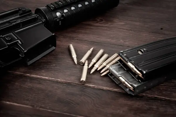 Rifle and Ammunition with magazine on wooden table background