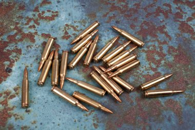 Ammunition on rust metal background clipart