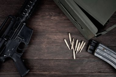 Rifle and Ammunition with magazine on wooden table background clipart