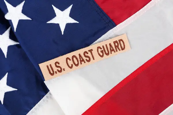 stock image U.S. Coast Guard Branch Tape on national USA flag background