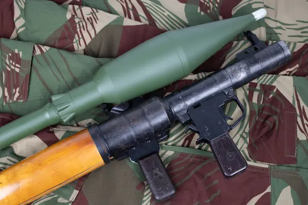 stock image rocket propelled grenade launcher RPG 7 on camo uniform background