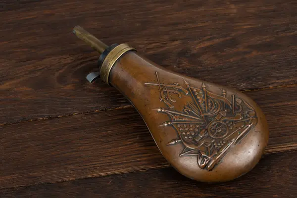 stock image Old west gunpowder flask on wood deck background