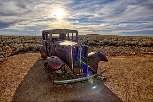 The shell of an old Model-T Car mounted on concrete pillars marking the old historic Route 66 within the Petrified Forest National Park Arizona. Due to the bright sun HDR toning was used.