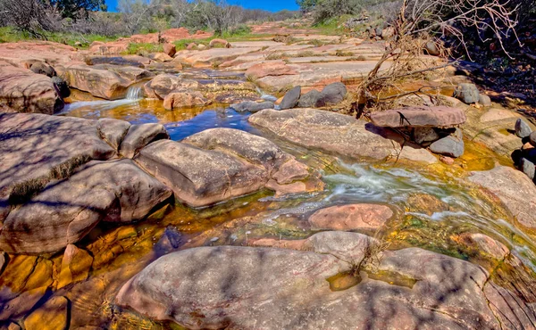 A tributary creek that drains into Dry Beaver Creek south of Sedona AZ. This section is called Beaver Flats because of the flat chunks of red sandstone that cover the creek bed.