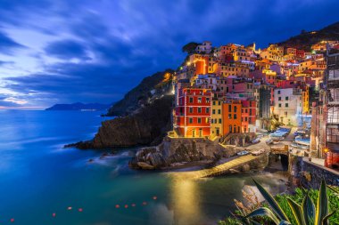 Riomaggiore, Italy, in the Cinque Terre coastal area during blue hour.