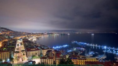 Naples, Italy aerial skyline on the gulf from night till dawn.