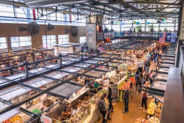 MILWAUKEE, WISCONSIN - MAY 19, 2018: Shoppers in the interior of Milwaukee Public Market. The market opened in 2005. clipart