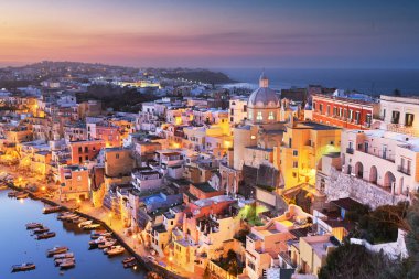 Procida, Italy old town skyline in the Mediterranean Sea during dusk.