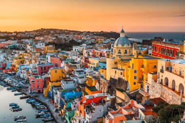 Procida, Italy old town skyline in the Mediterranean Sea during dusk.