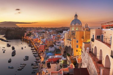 Procida, Italy old town skyline in the Mediterranean Sea during dusk.
