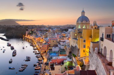 Procida, Italy old town skyline in the Mediterranean Sea during dusk.