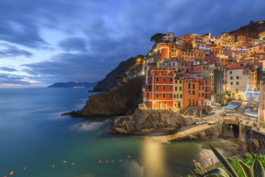 Riomaggiore, Italy, in the Cinque Terre coastal area during blue hour.