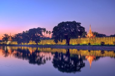 Mandalay, Myanmar at the royal palace moat at dusk. clipart