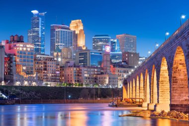 Minneapolis, Minnesota, ABD. Mississippi Nehri 'ndeki Stone Arch Köprüsü ile mavi saatte gökyüzü..
