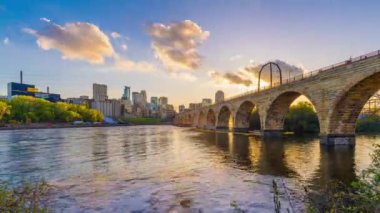 Minneapolis, Minnesota, ABD alacakaranlıkta Mississippi Nehri 'ndeki Stone Arch Köprüsü ile gökyüzü.