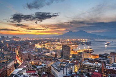 Naples, Italy city skyline overlooking the port towards Vesuvius at dawn.