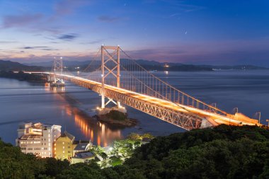 Onaruto Bridge connecting  Awaji Island to Tokushima, Japan at twilight. clipart