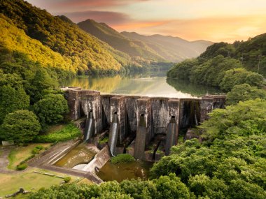 Honen'ike Pond Dam in the Sanuki Mountain range at Kan'onji, Kagawa Prefecture, Japan. The structure dates from 1930. clipart