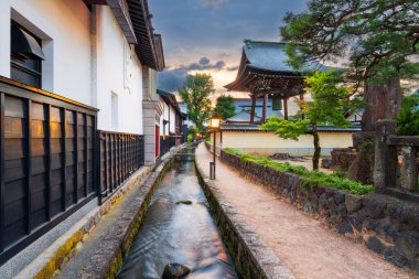 Hida, Gifu, Japan on Shirakabe Dozogai Street at twilight. clipart