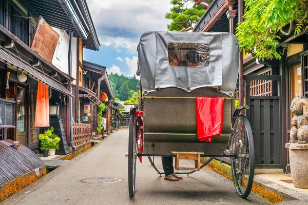 stock image Takayama, Japan at the historic Sannomachi Street in the old town with a rickshaw.